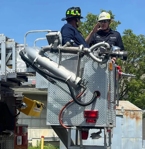 Two members inside a firetruck